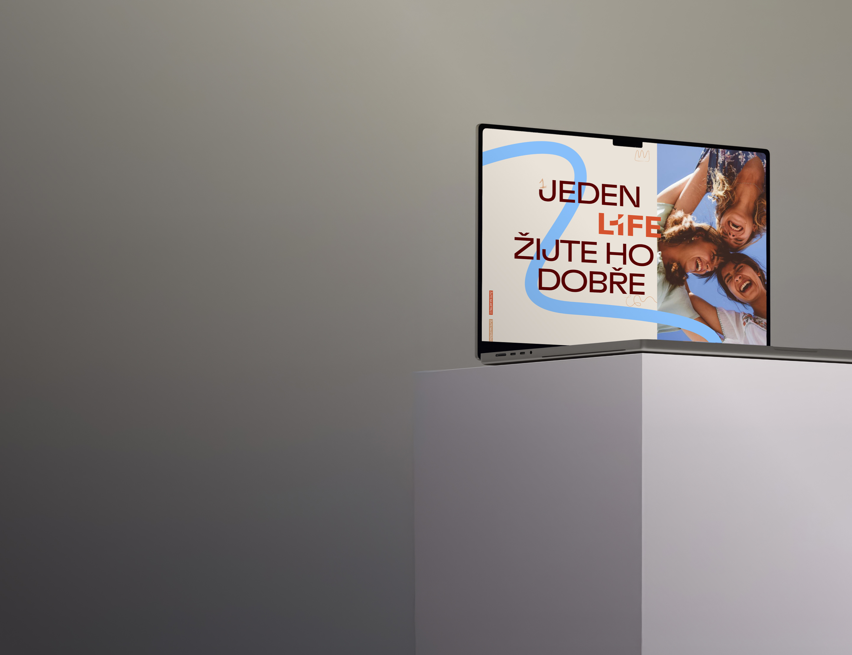 A modern television on a minimalist stand, with a screen displaying the words “One Life—Live It Well” and a smiling family below the text on a gray background.