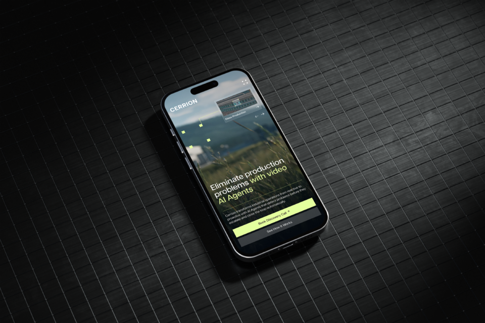 A phone featuring the Cerrion website and a headline about eliminating production problems using video AI agents