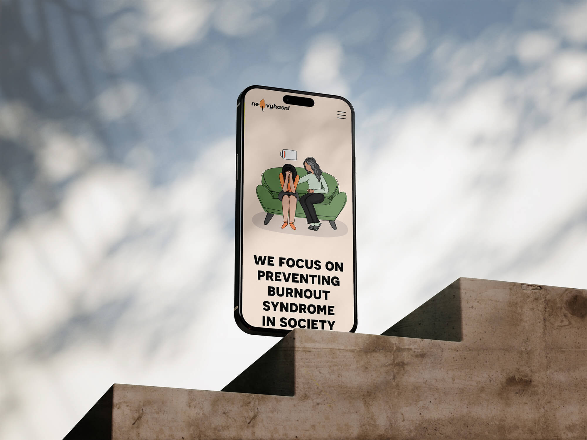 A smartphone displays a website focused on preventing burnout in the workplace, resting on stone steps with a blurred blue sky in the background.