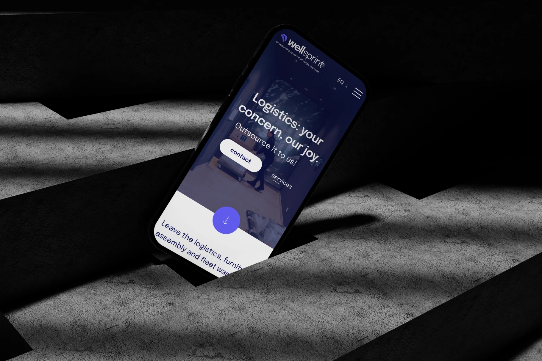 Smartphone with website on concrete stairs with dramatic lighting.