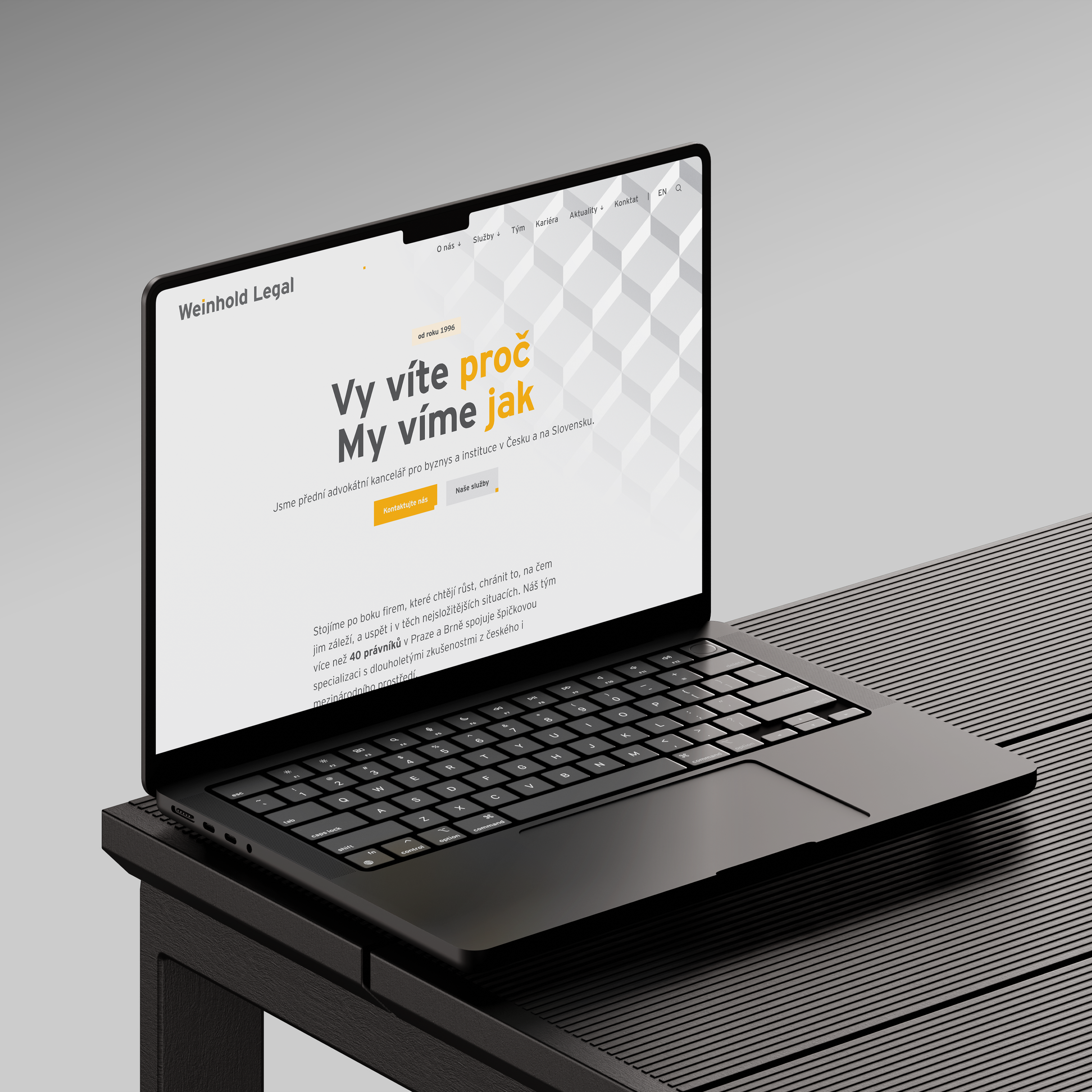 An open black laptop on a wooden table displays the Washhold Legal website with the text "You know why. We know how" on a gray background with a 3D pattern on the screen